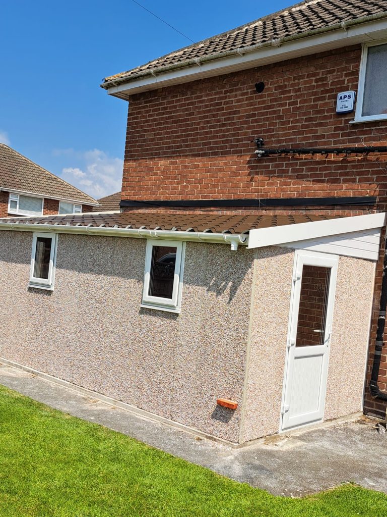 Lean-to garage with a simulated tile effect roof